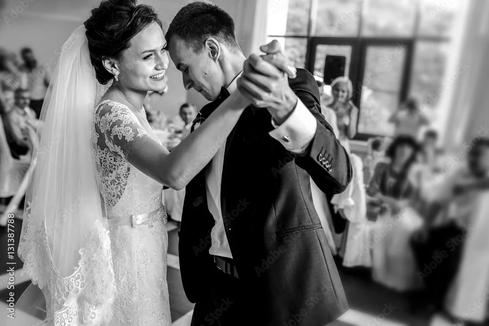 A newlywed couple shares a joyful moment after an intimate wedding ceremony, embracing in a beautiful outdoor setting.