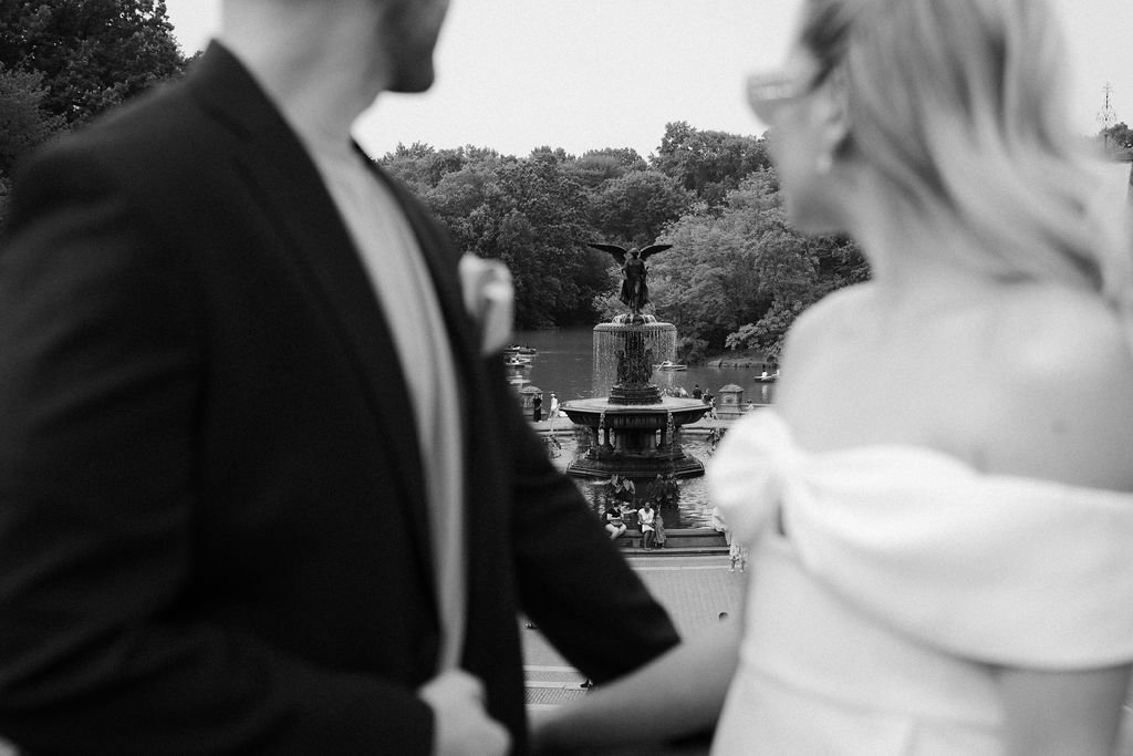 Bride and groom admiring a fountain in Central Park, on the way to their Cakewalk elopement.