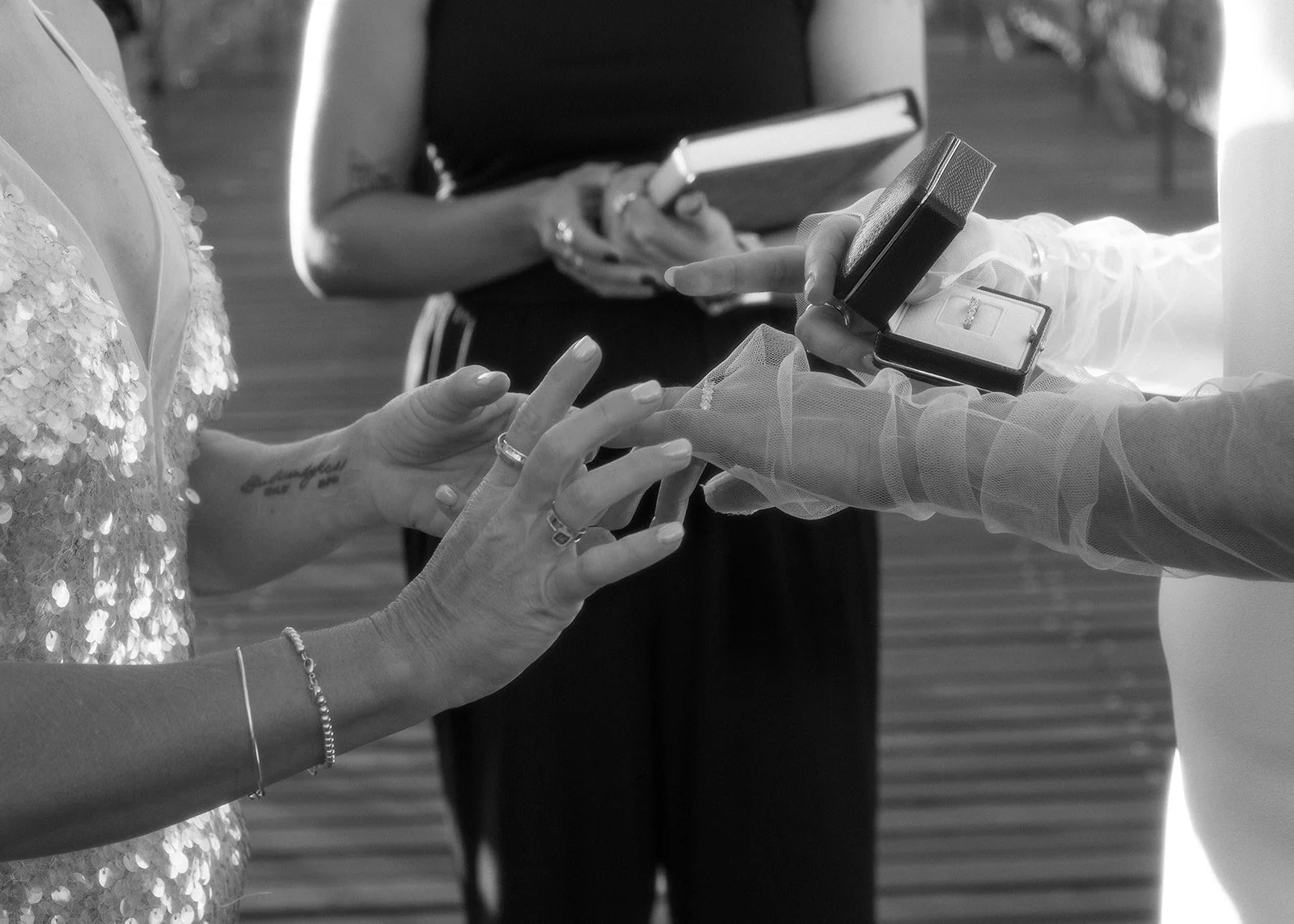 LGBT Australian couple exchanges rings during their wedding ceremony on the Brooklyn Bridge.