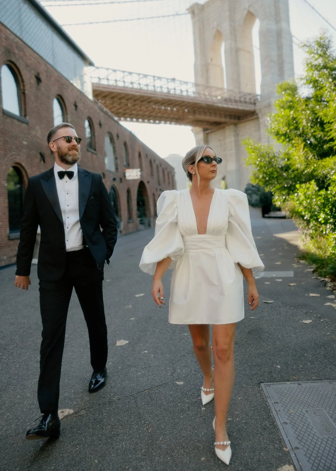 Bride and groom walking away from the Brooklyn Bridge after their Cakewalk elopement.