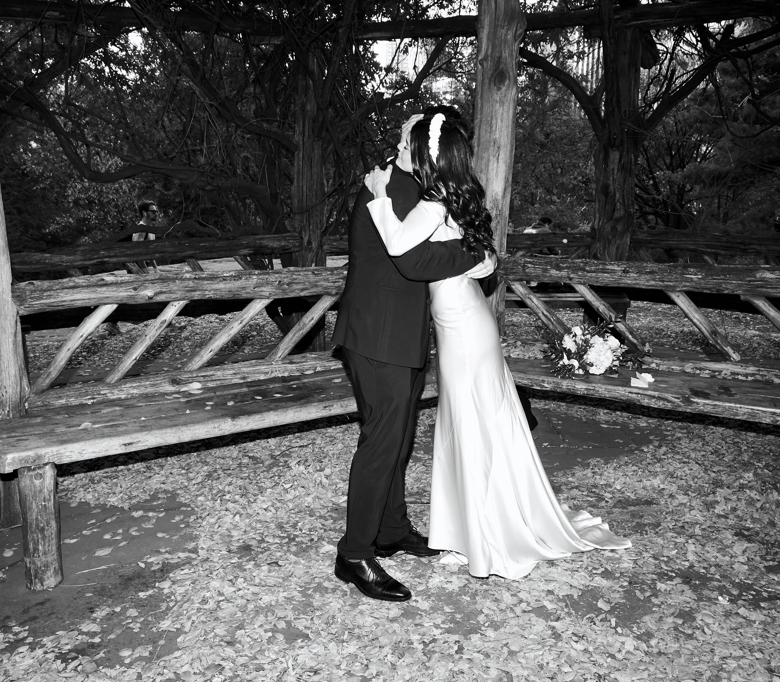 Black and white photo of Sharifa and Jafar hugging during their Cop Cot ceremony in Central Park.