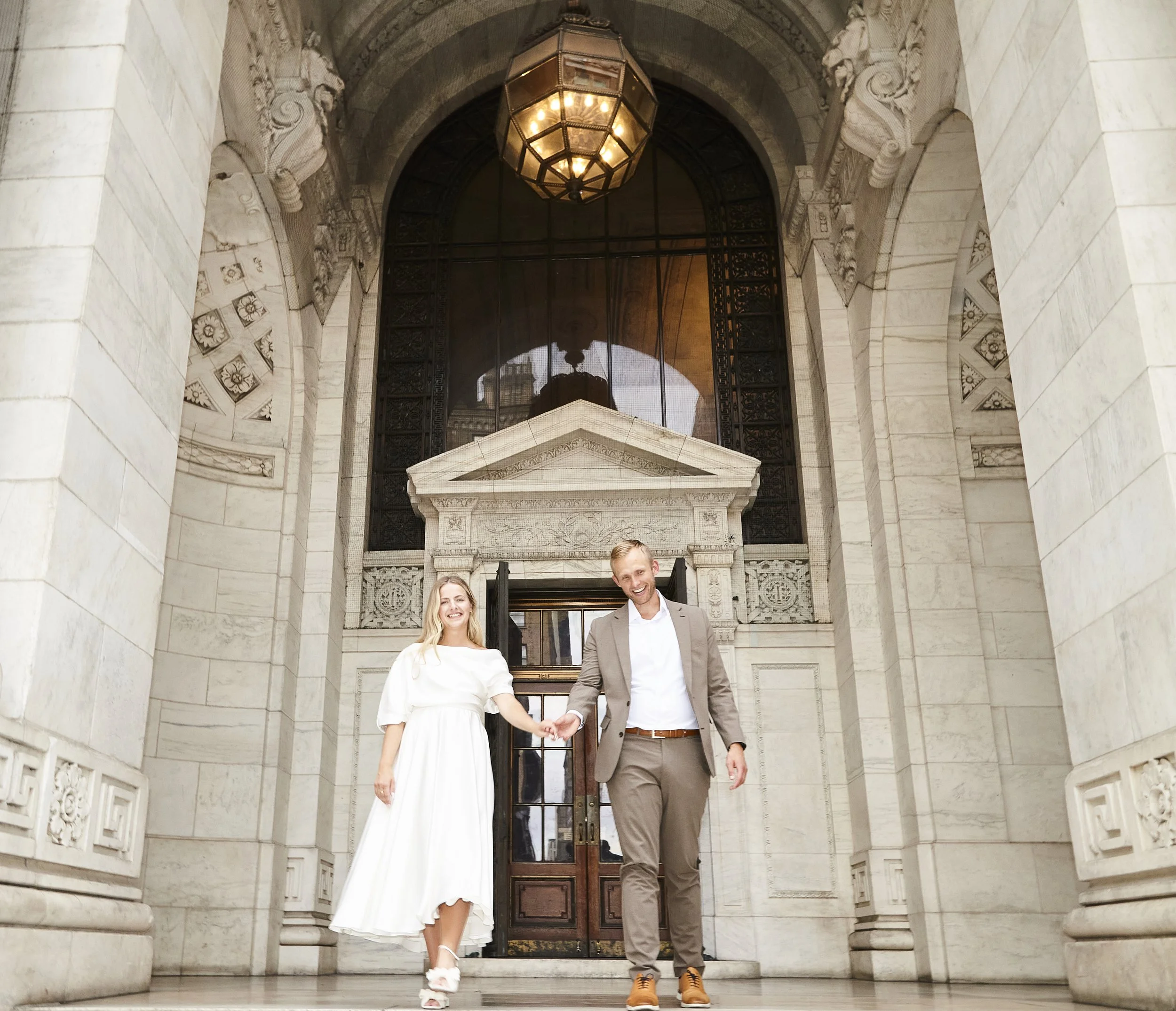 Bride and groom walking down the stairs at Bryant Park after their Cakewalk elopement.