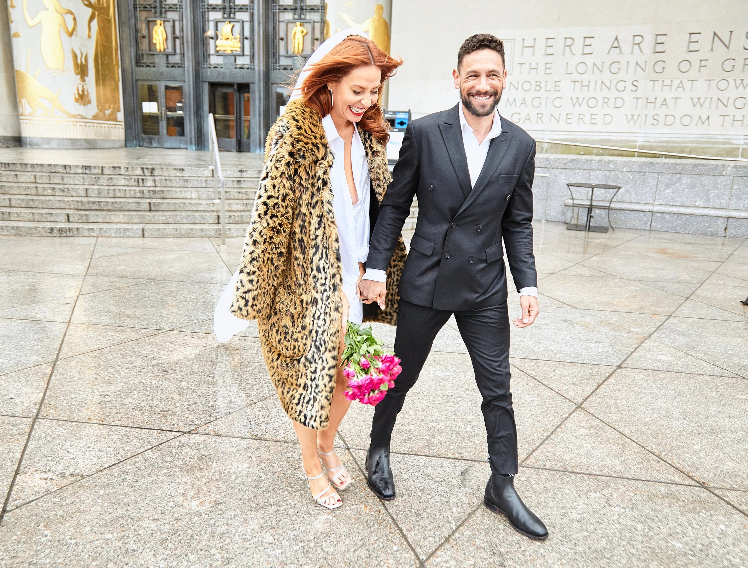 Bride and groom walking in front of Brooklyn Central Library.