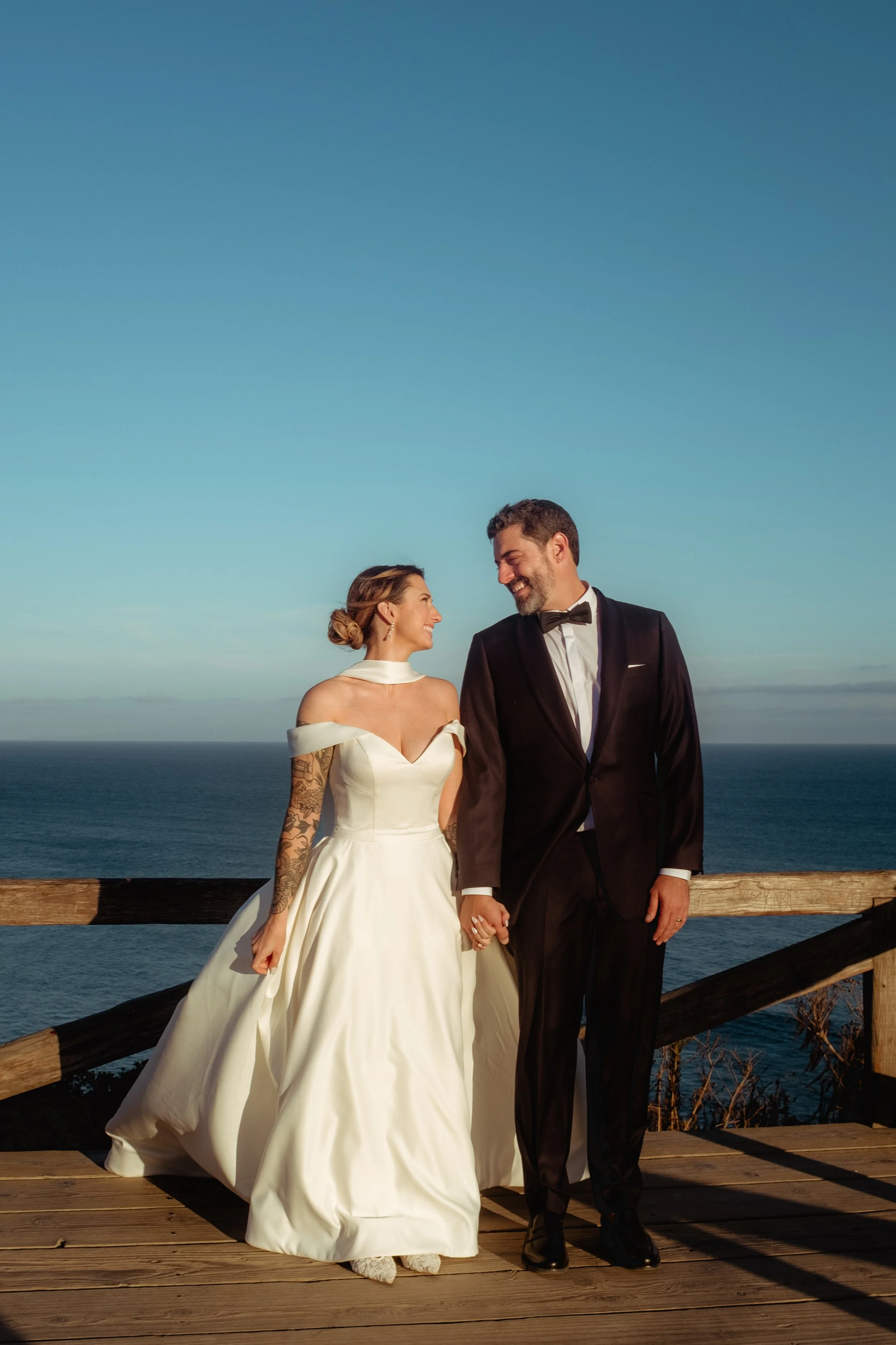 Bride and groom looking at each other with the ocean in the background at Point Dume after their Cakewalk micro wedding.
