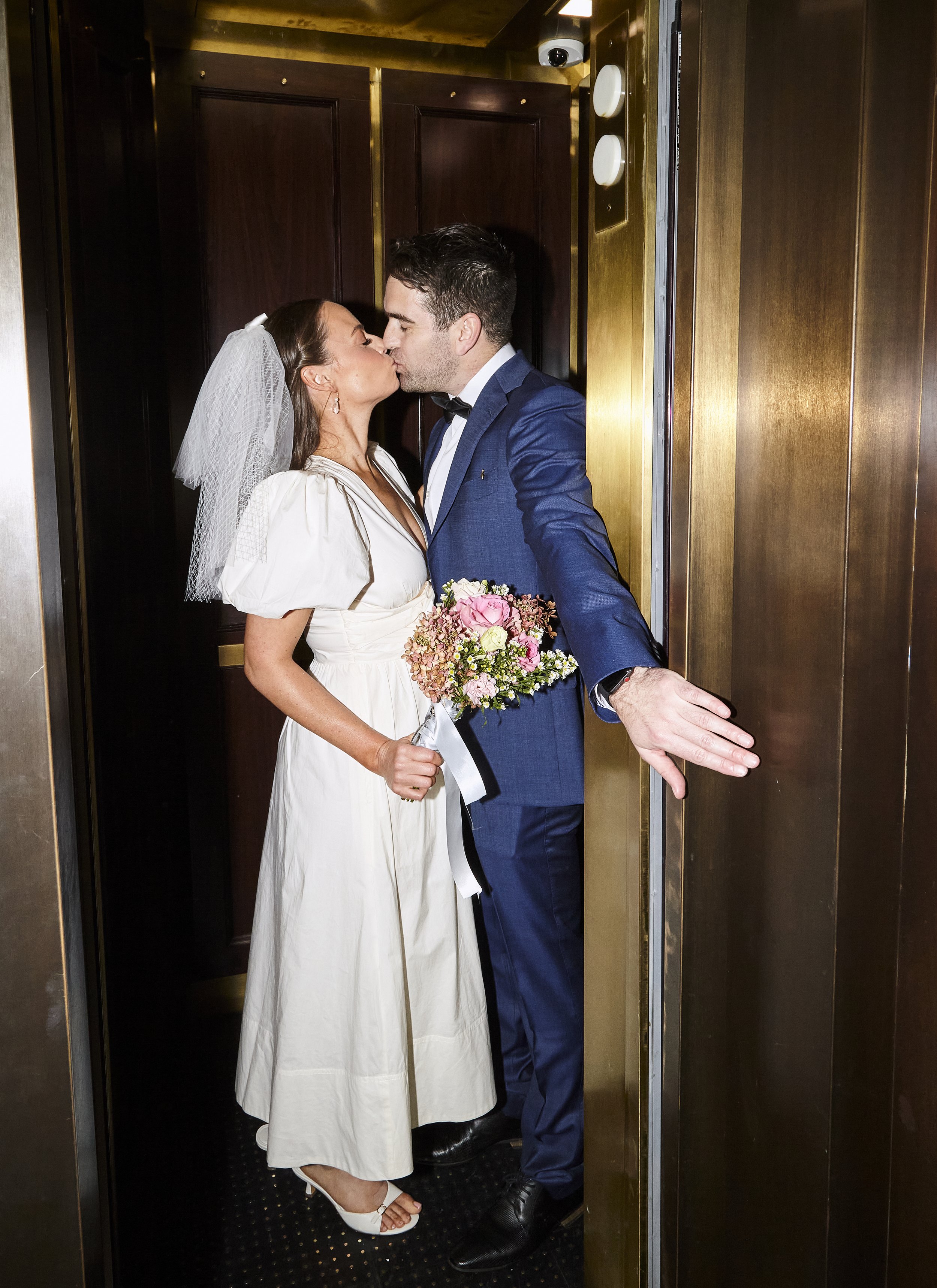 Couple kissing in the elevator before their elopement with Cakewalk which has documentary style photography.