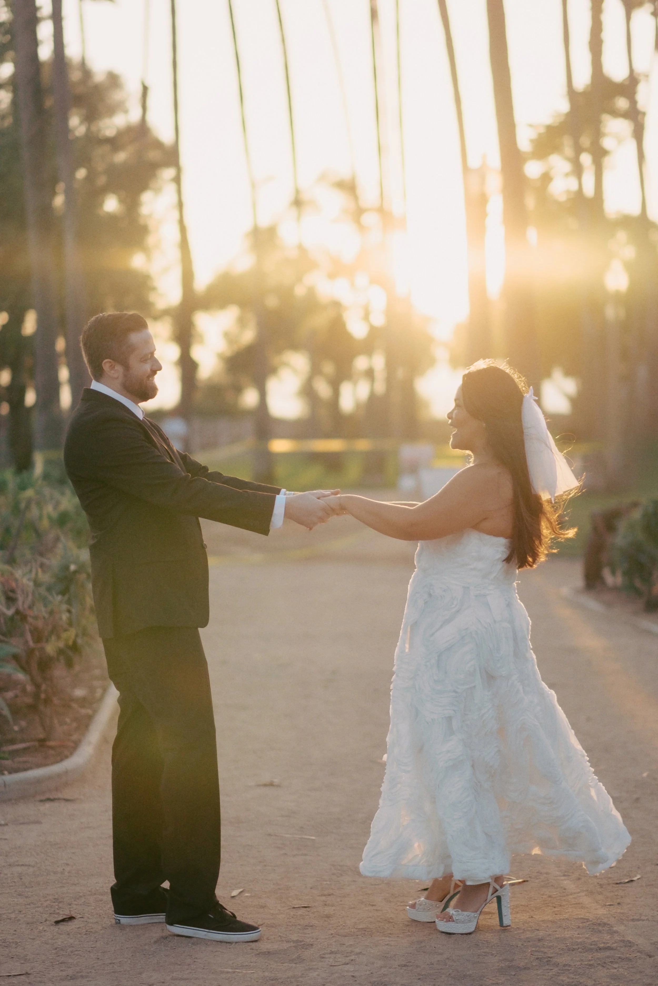 Couple dancing in the pathway in Santa Monica Palisades Park during their  wedding celebration by Cakewalk elopements.