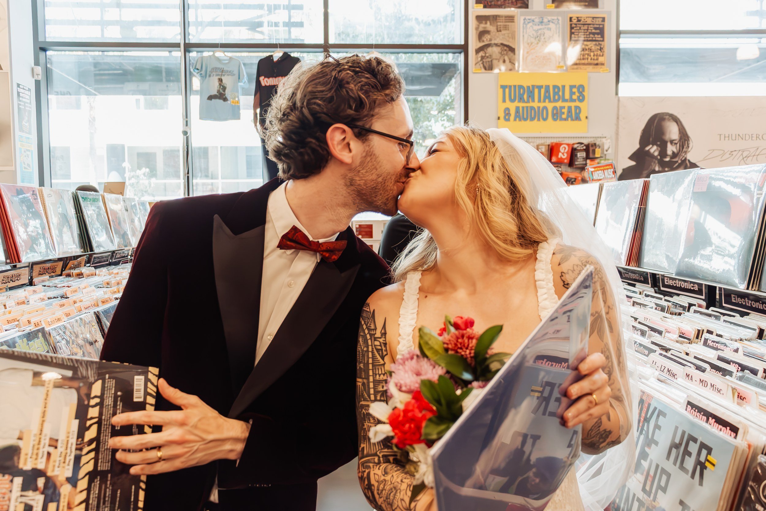Newlyweds kissing in the record racks at Amoeba Music on Hollywood Boulevard.