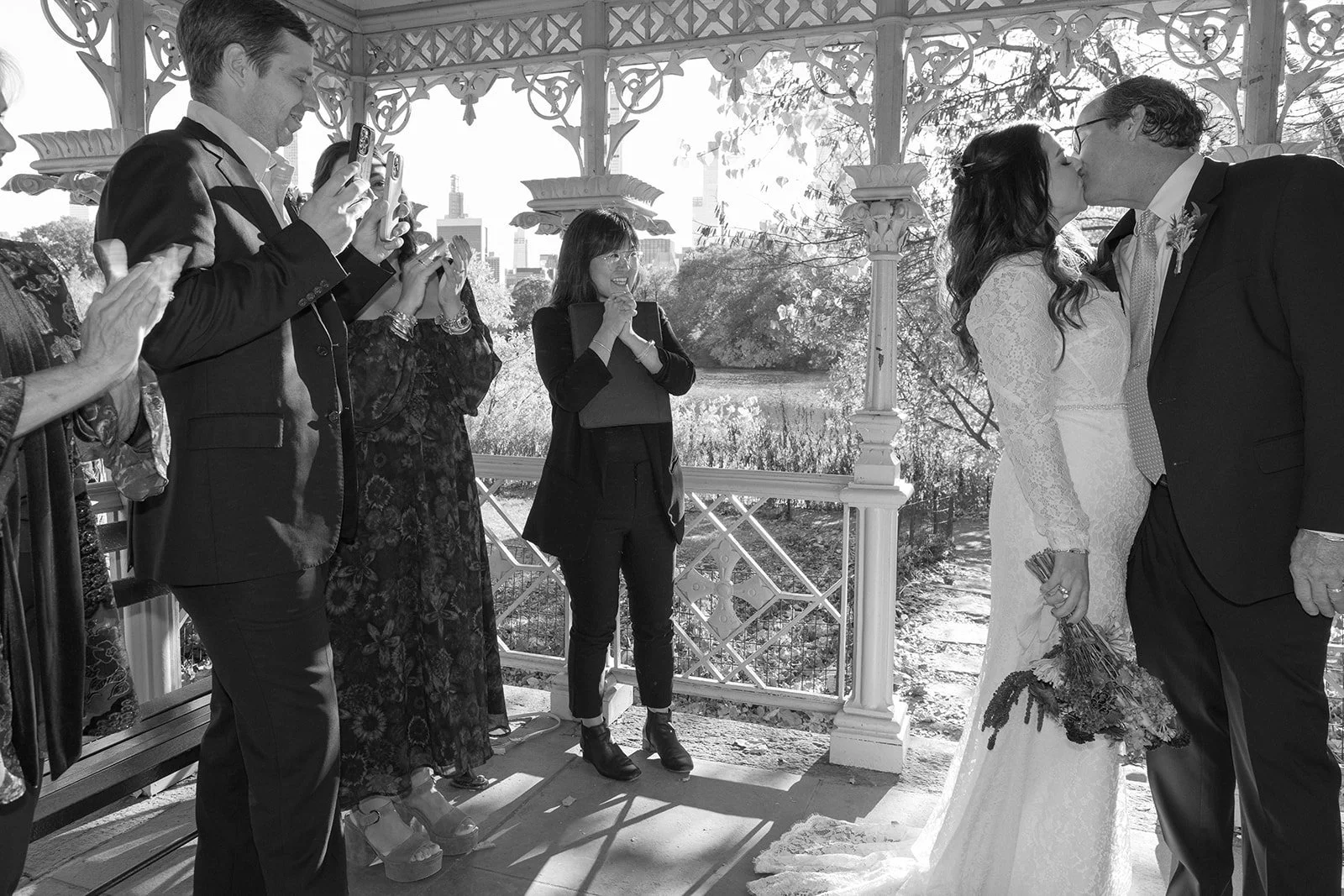 An intimate wedding ceremony at the Ladies Pavilion in NYC, with the officiant leading a personalized Cakewalk ceremony for the couple.