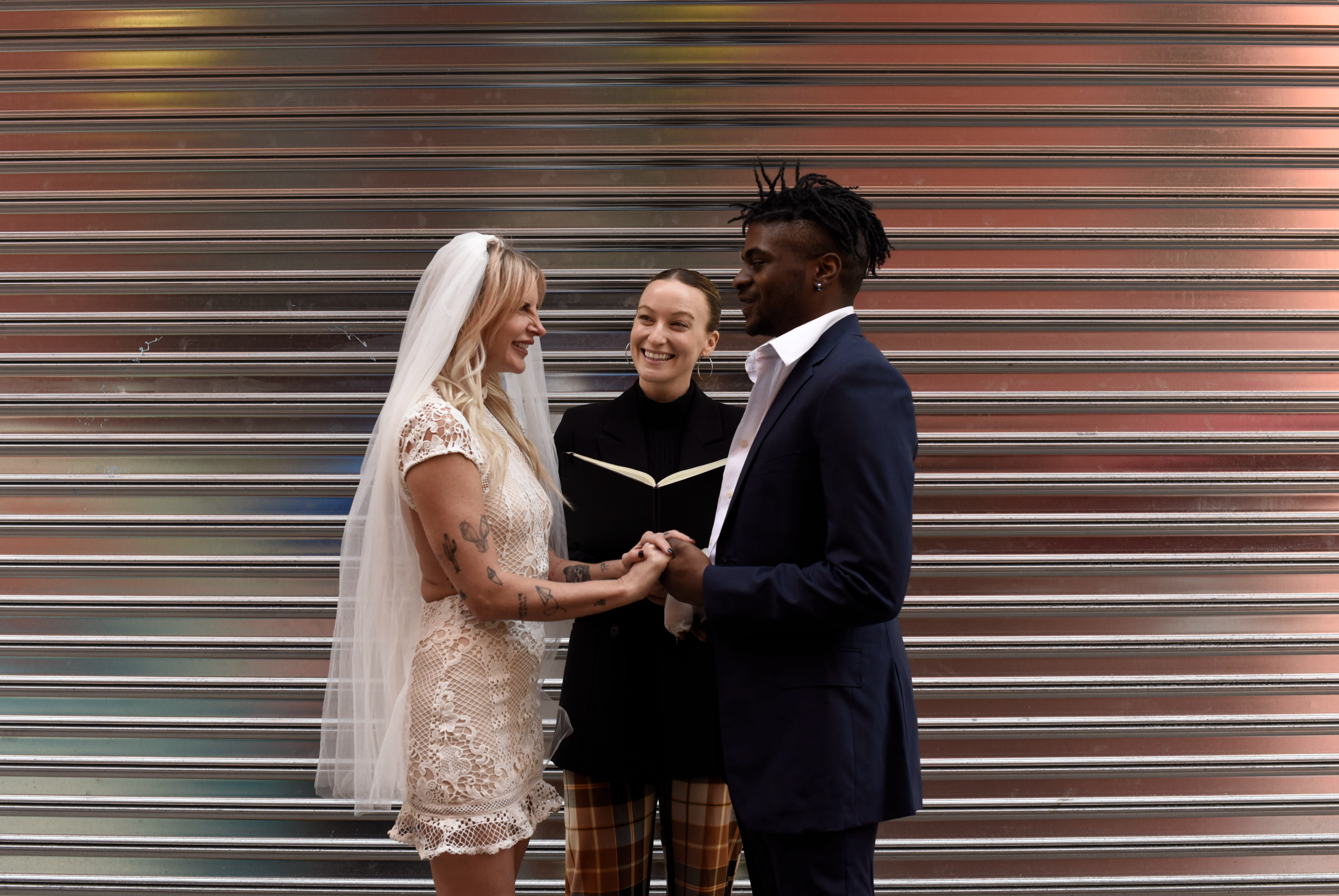 Bride and groom being married by their Cakewalk officiant during their elopement ceremony on Doyers Street.
