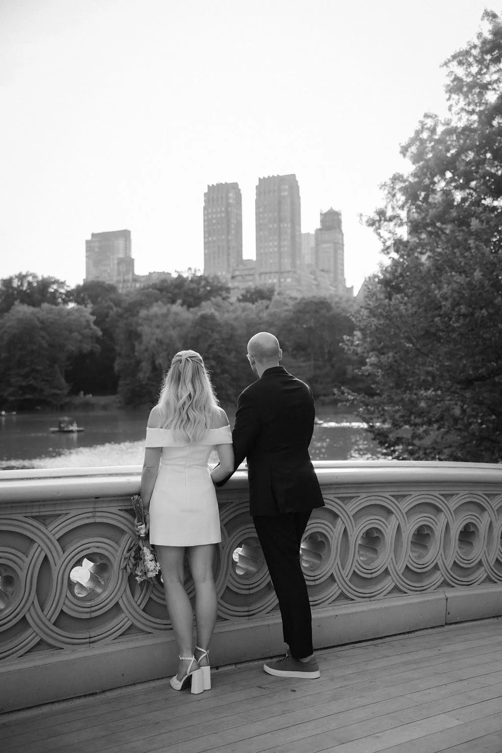 Chloe and Sam outdoors during a Cakewalk NYC elopement portrait at Wagner Cove, bride holding her bouquet.