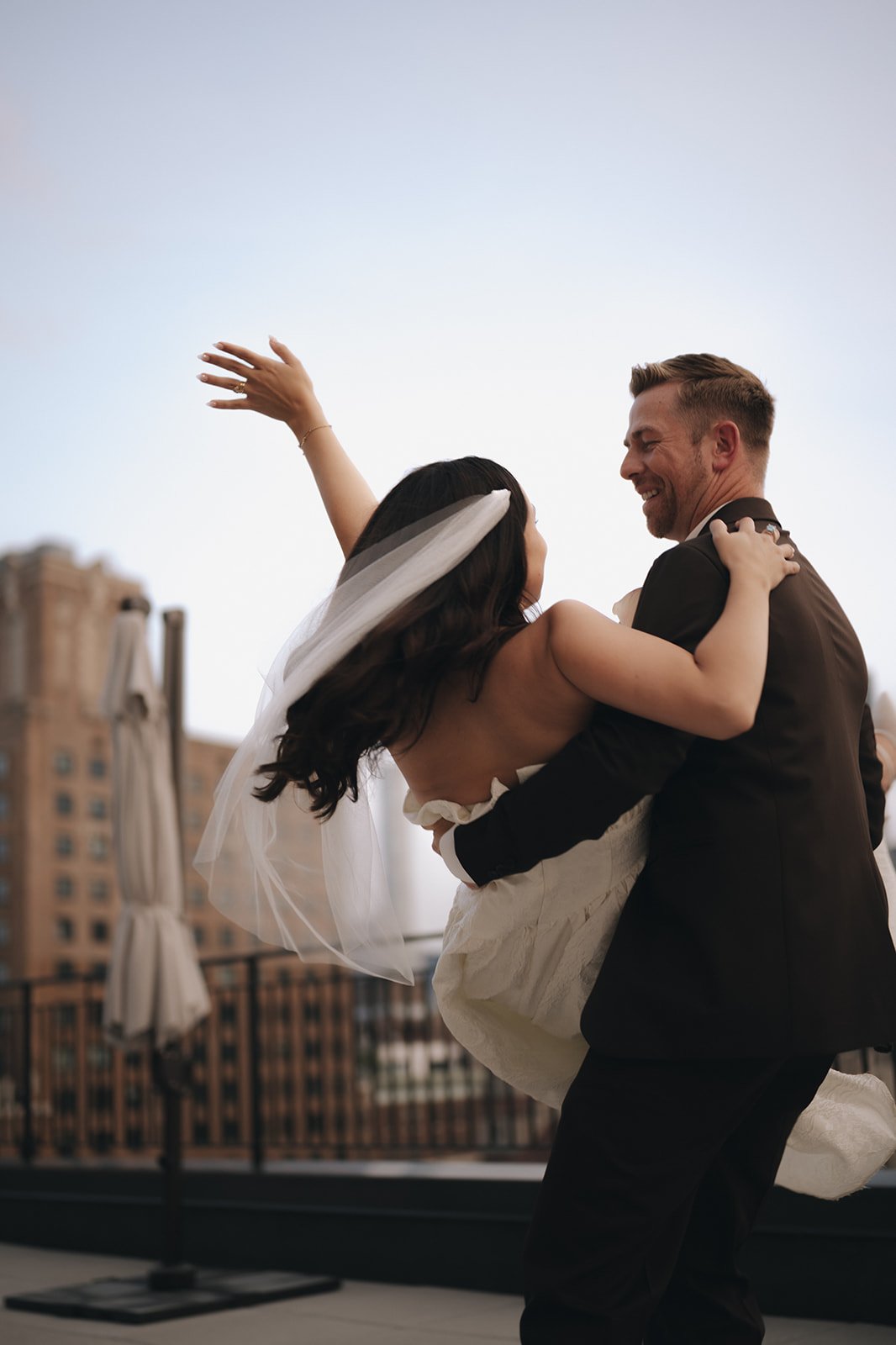 Bride and groom dancing on a Manhattan rooftop after their wedding ceremony.