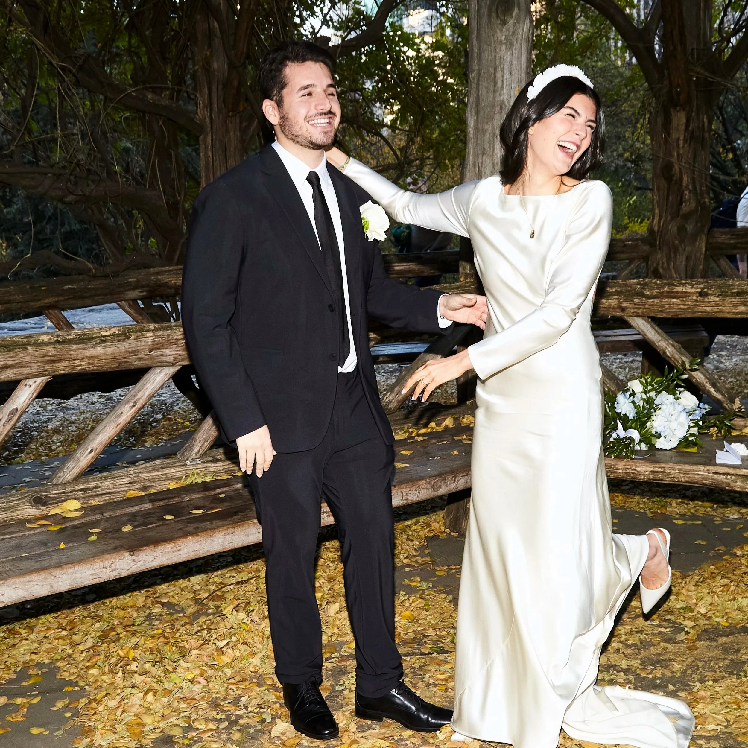 Sharifa and Jafar standing on fallen leaves during their fall Cop Cot ceremony in Central Park.