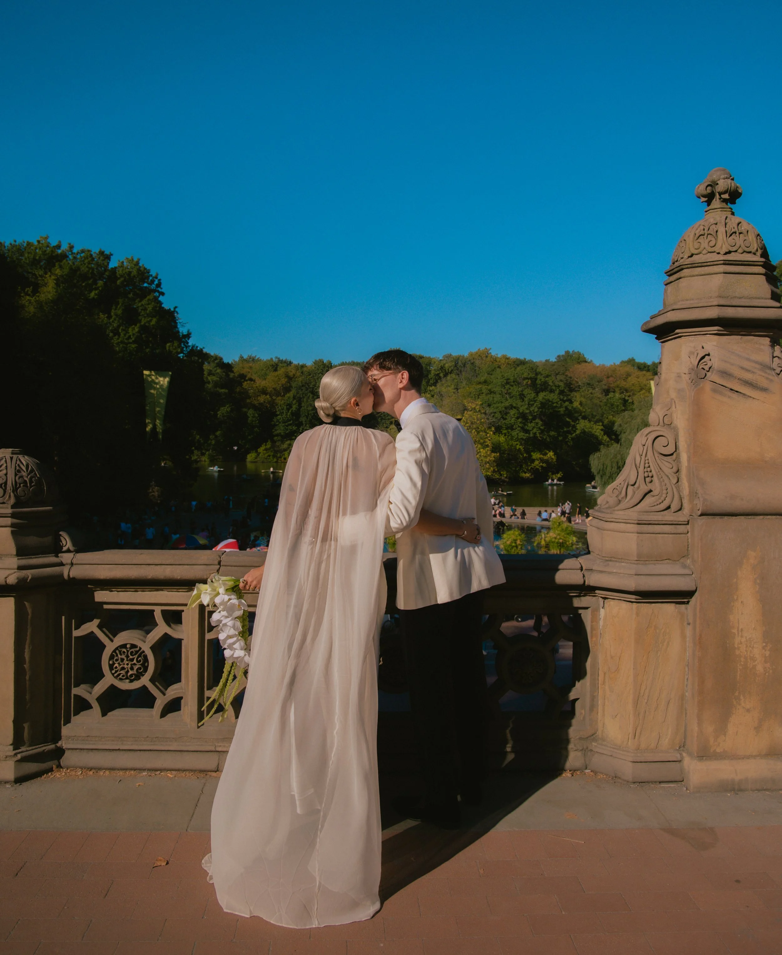 Documentary style photography of a couple kissing after their wedding at Bethesda Terrace.