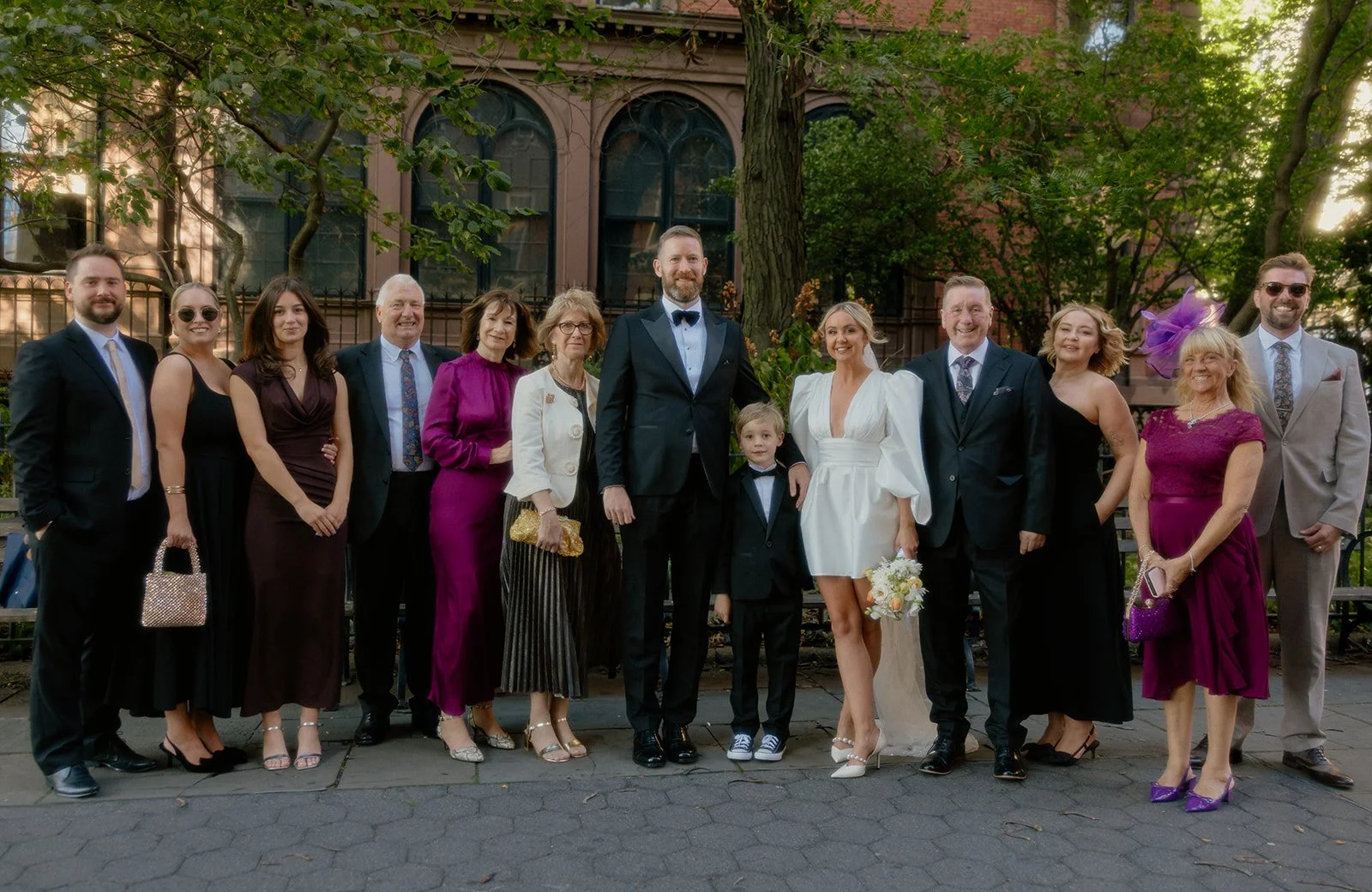 Bride, groom and family posing at Brooklyn Heights Promenade after their Cakewalk micro wedding.