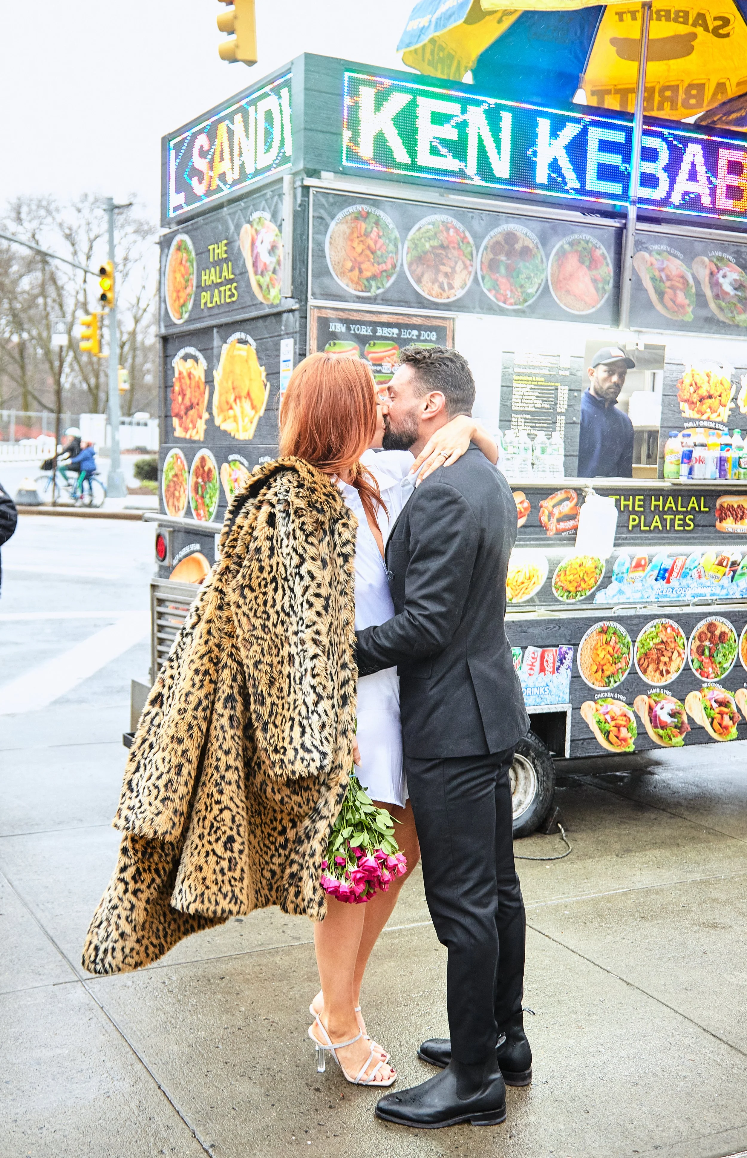 Bride and groom kissing in front of a kebab food truck on the streets of Brooklyn.