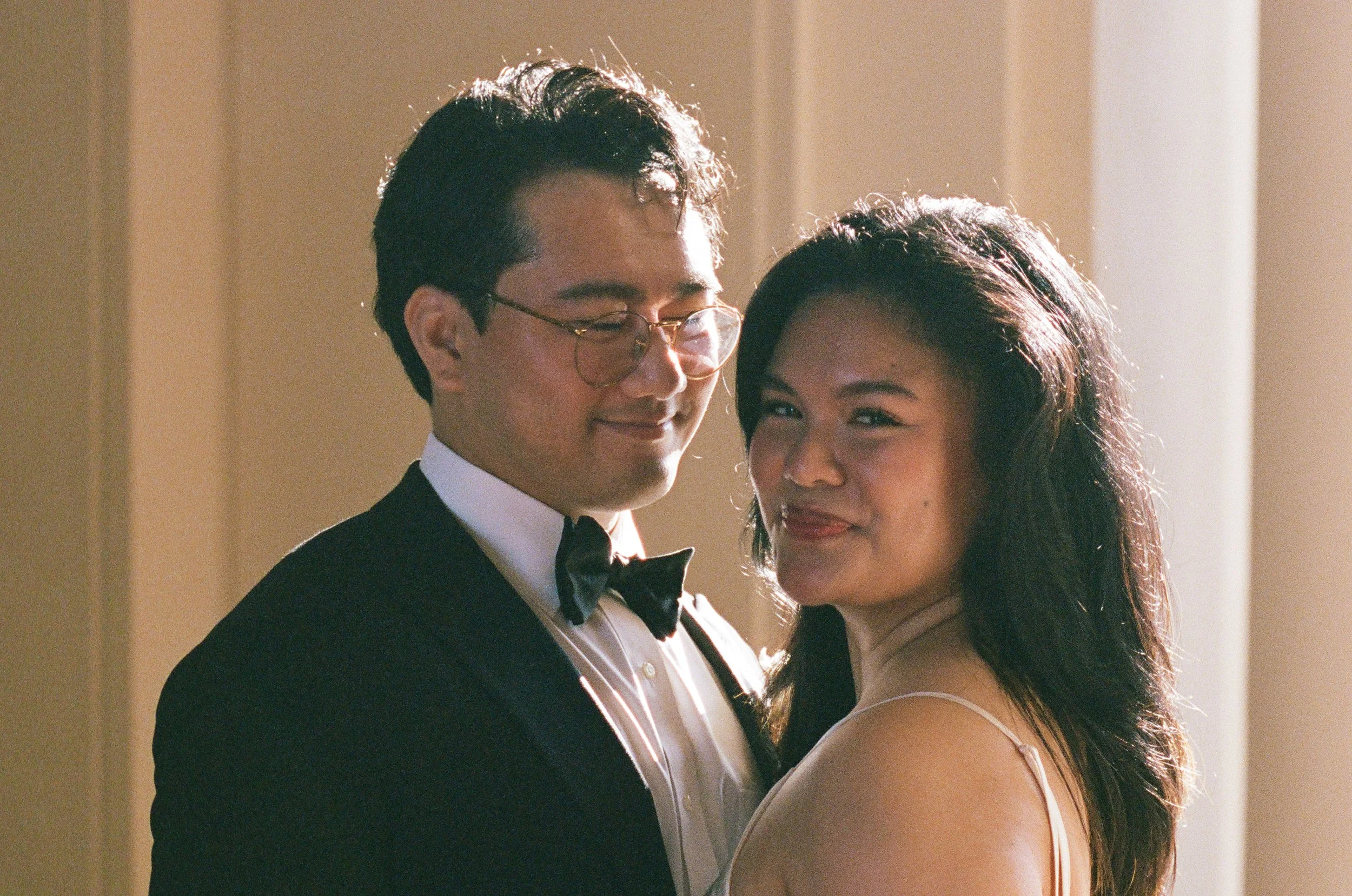 Film photo of bride and groom close up at Pasadena City Hall at sunrise.