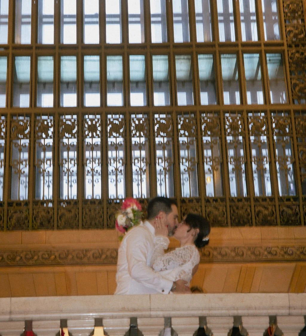 Couple kissing on the balcony after their Cakewalk elopement in Grand Central Station in NYC.