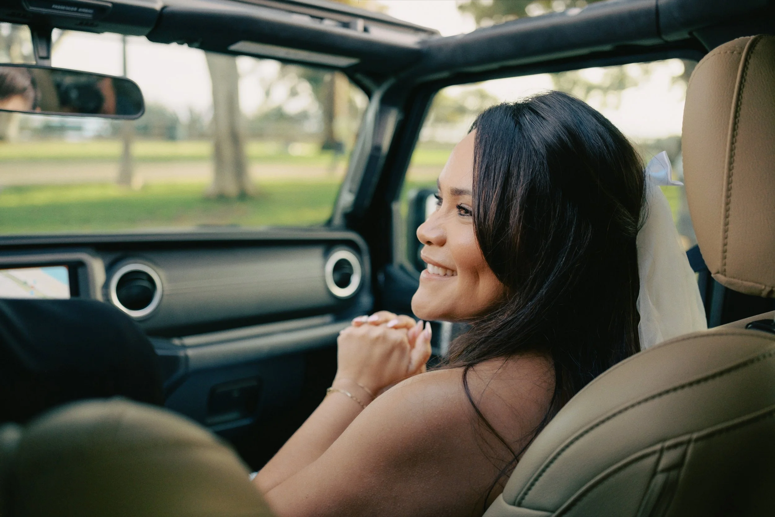 Bride sitting inside Black Jeep Wrangler in Santa Monica on the way to her Cakewalk elopement ceremony.