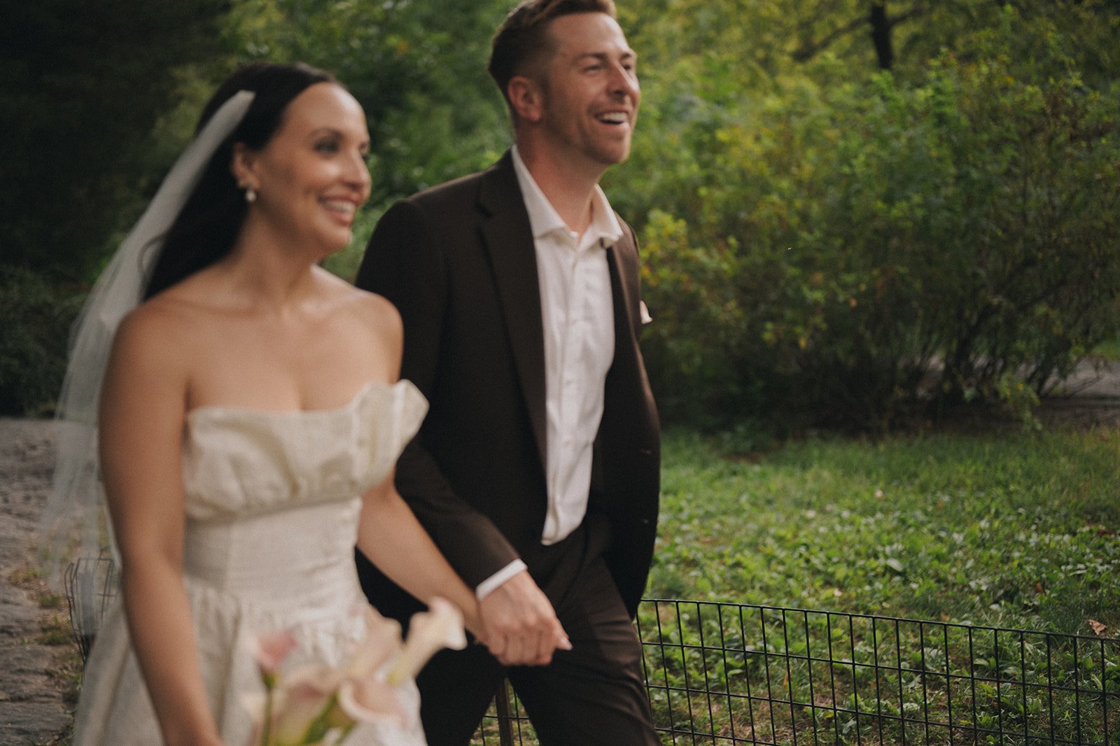 Bride and groom walking through Central Park after their Cakewalk elopement ceremony.