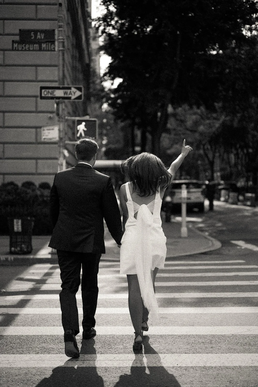 Bride and groom crossing the street in Manhattan.