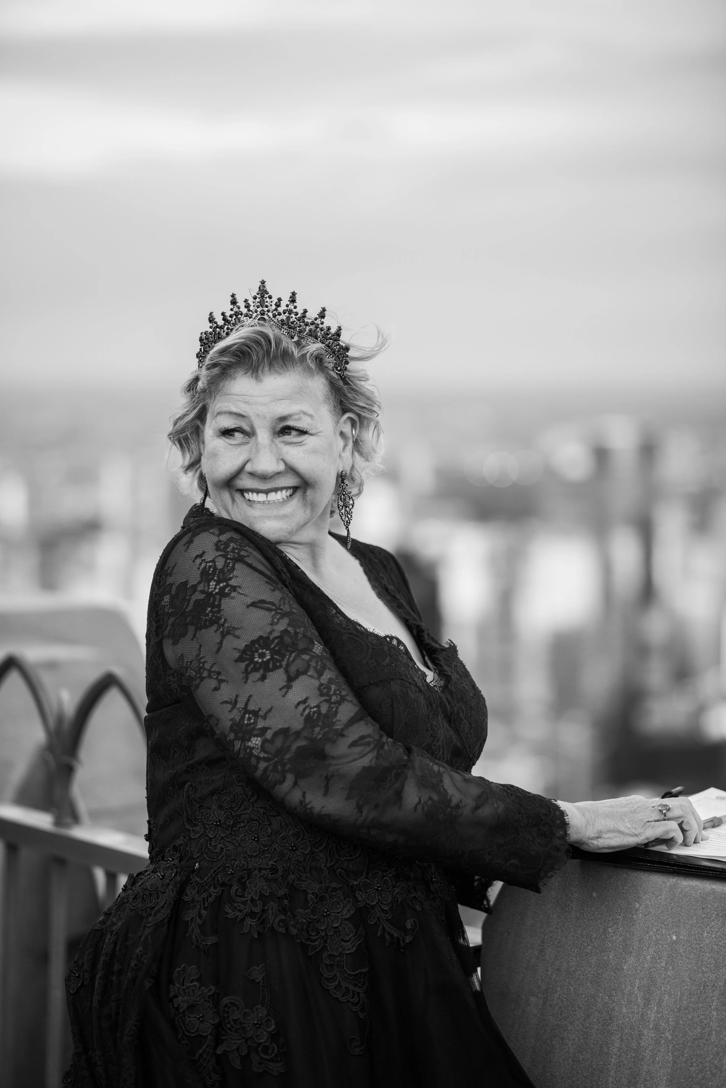 A woman wearing black and a tiara smiling at the Top of the Rock after her Cakewalk elopement.