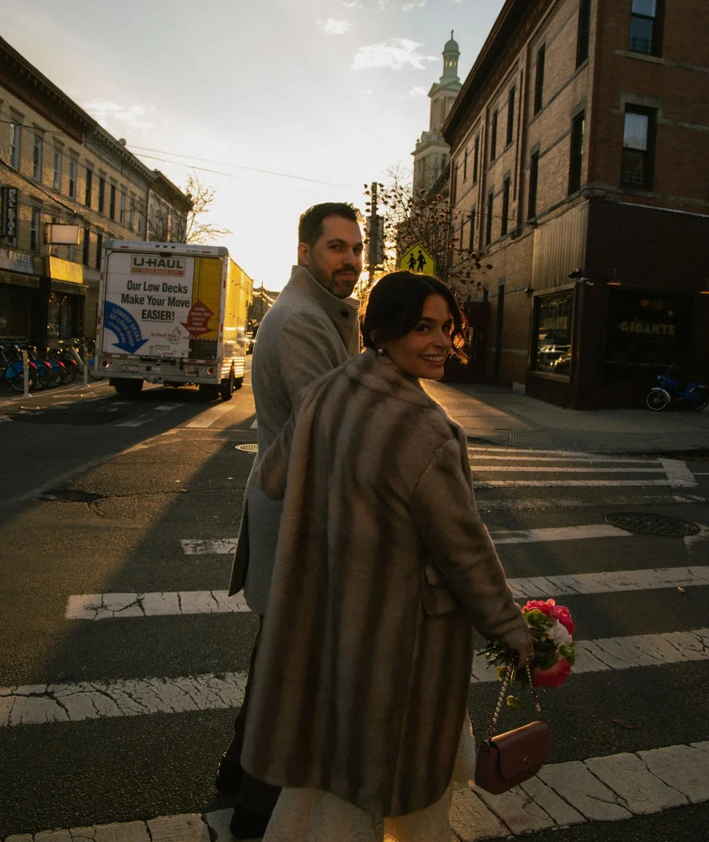 Newly married couple crossing the street in after their Cakewalk elopement ceremony.