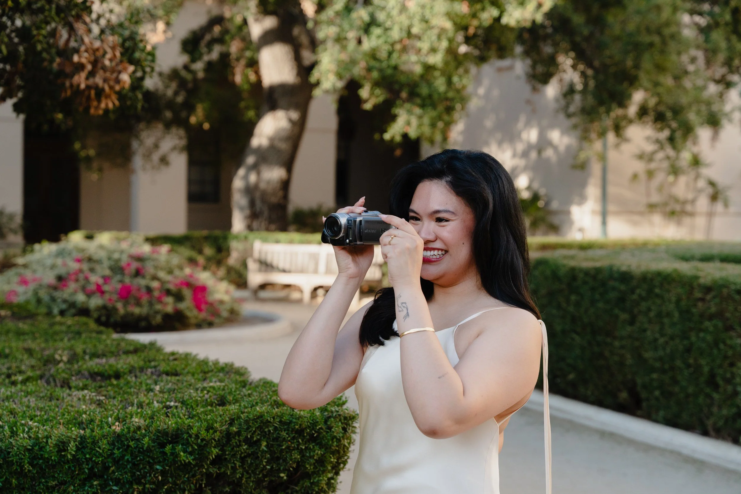 Bride filming in the courtyard after a sunrise Pasadena City Hall elopement.