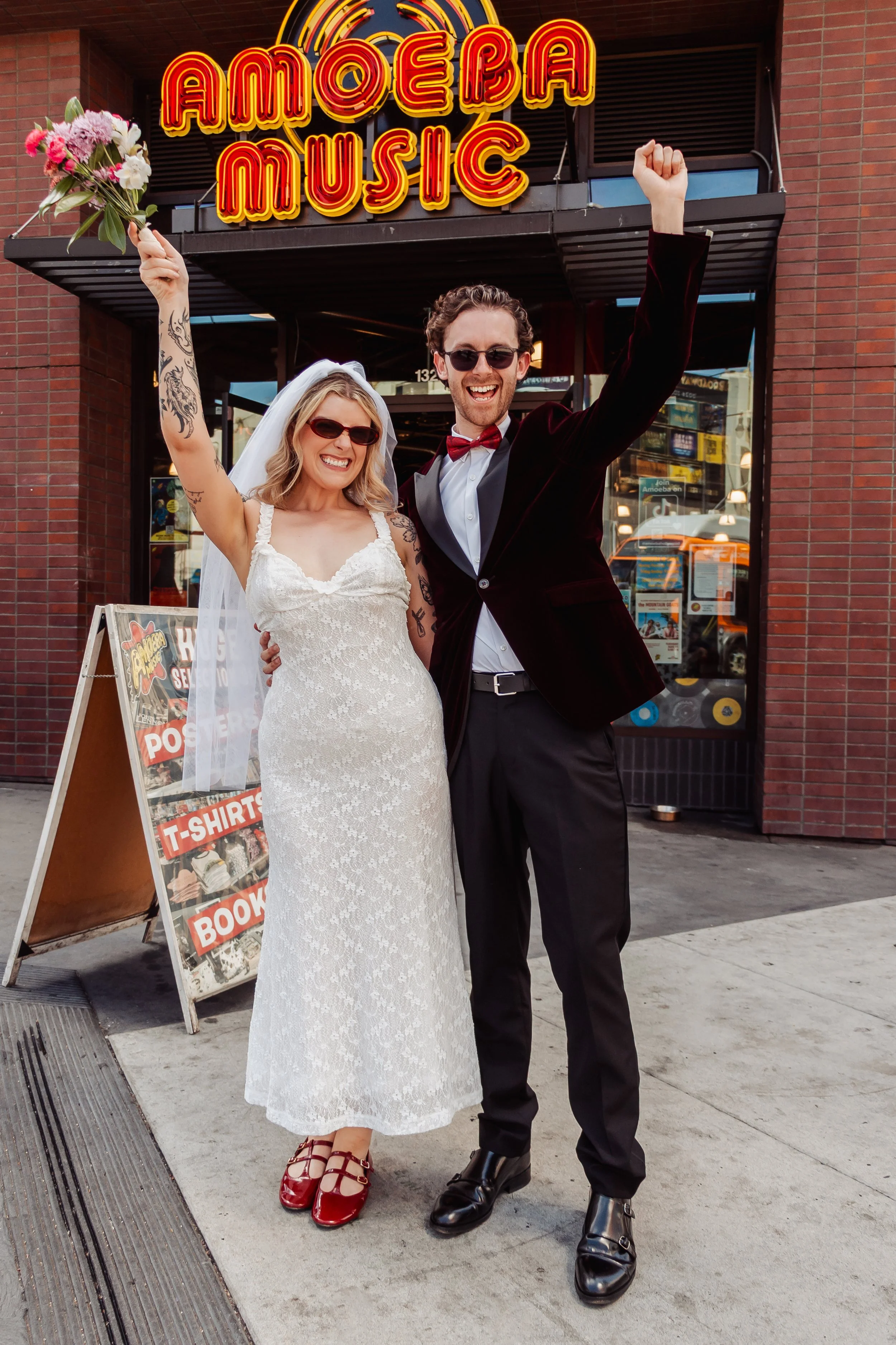 Couple celebrating elopement in front of Amoeba Music on Hollywood Blvd.
