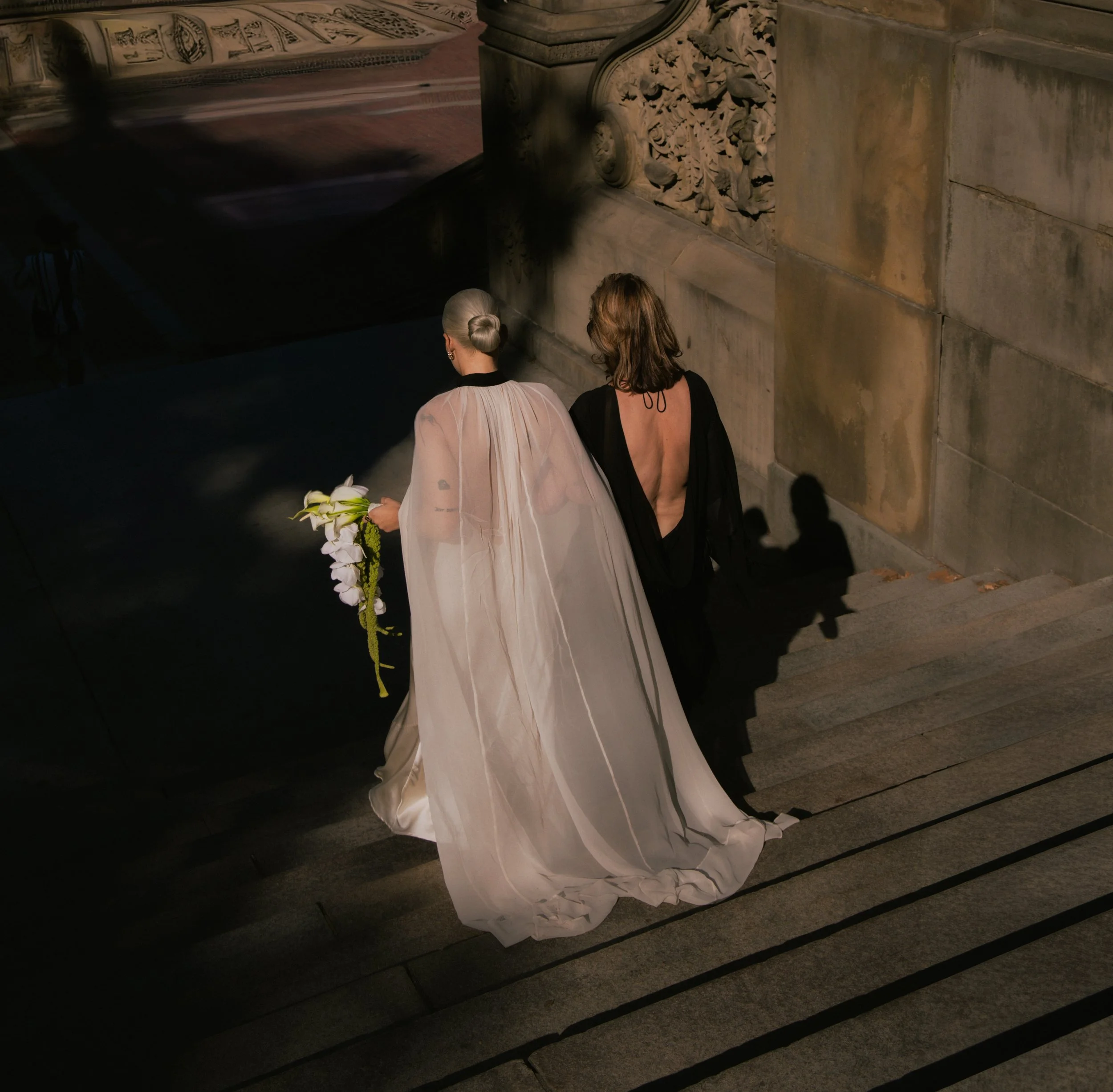 Bride and her mother walk down the stairs at Bethesda Terrace in Central Park.