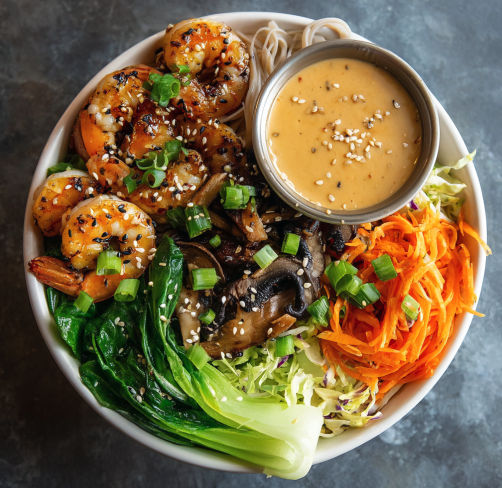 For Students: Lean Muscle Bowl with Shrimp, Brown Rice Noodles, Bok Choy, Roasted Mushrooms, Shredded Carrots, Cabbage, Scallions, Sesame Seeds and a Peanut Sesame Sauce