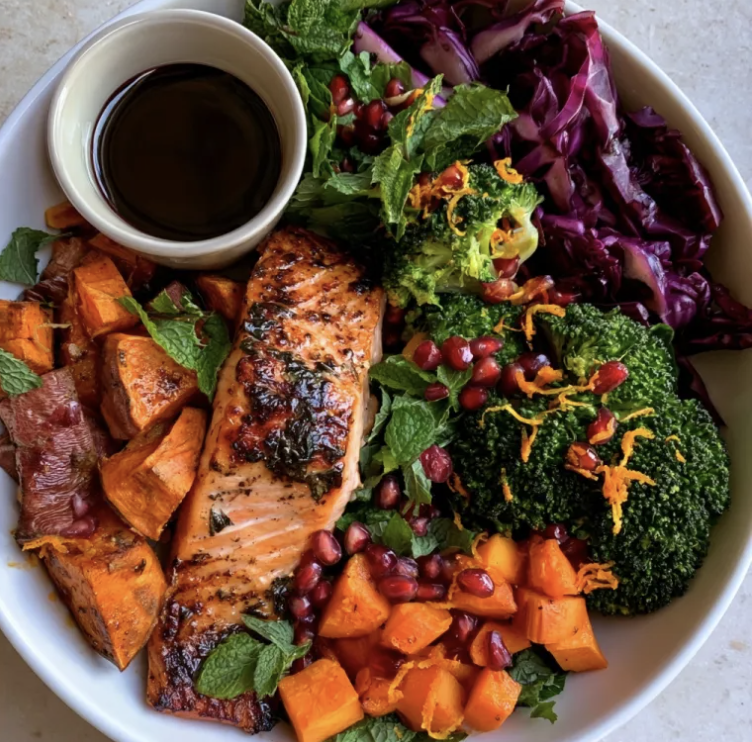 Antioxidant Glow Bowl with Sumac Basil Salmon, Roasted Sweet Potato, Carrots, Broccoli, Red Cabbage, Mint, Pomegranate, Orange Zest, Pomegranate Balsamic Glaze