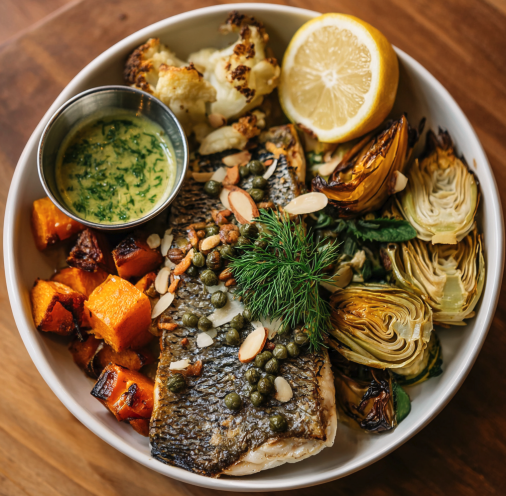 Citrus Groove Bowl with Caper Dill Branzino, Roasted Butternut Squash, Roasted Artichokes, Zucchini, Leeks, Fennel, Dill, Almonds, Lemon Caper Dressing