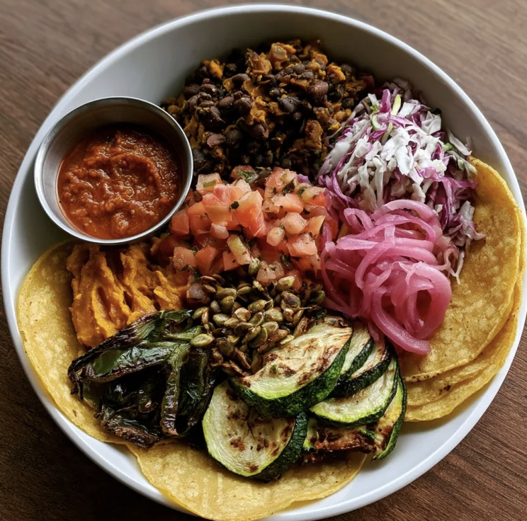 For Pros: Sonoran Taco Bowl with Calabacitas and Black Beans, Corn Tortillas, Tomatoes, Cabbage, Zucchini, Poblano Peppers, Pickled Onion, Pepitas, Roasted Salsa Roja