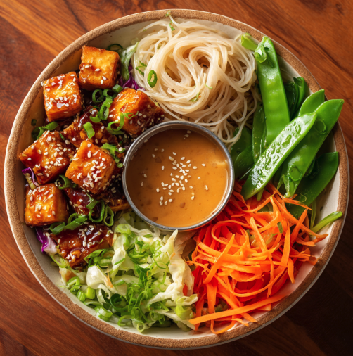 For Pros: Asian Street Bowl with General Tso’s Tofu, Brown Rice Noodles, Shredded Cabbage, Shredded Carrot, Snap Peas, Sesame Seeds, Scallions, Sesame Ginger Dressing