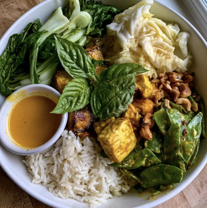 Harvest Nourish Bowl with Thai Coconut Pumpkin Curry Tofu, Basmati Rice, Bok Choy, Napa Cabbage, Snow Peas, Thai Basil, Cashews, Coconut Pumpkin Lemongrass Sauce