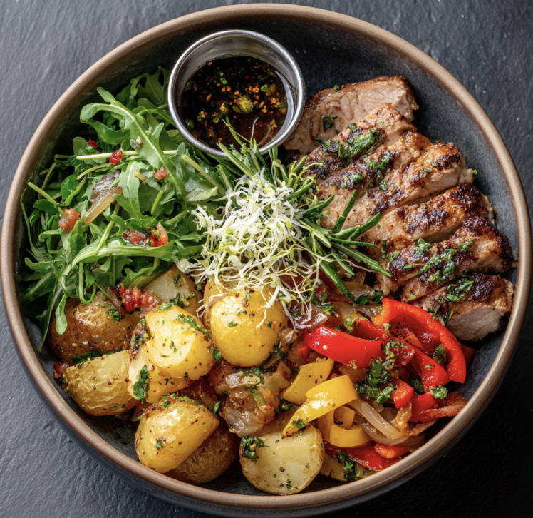For Pros: Herby Harvest Bowl with Oregano Pork Tenderloin, Roasted Potatoes, Caramelized Onions, Peppers, Tomatoes, Arugula, Parmesan, Microgreens, Tomato-Herb Vinaigrette
