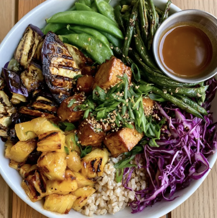 Teriyaki Vitality Bowl with Pineapple Teriyaki Tofu, Brown Rice, Eggplant, Snow Peas, Green Bean, Purple Cabbage, Grilled Pineapple, Scallion, Sesame Seed, Pineapple Teriyaki Glaze