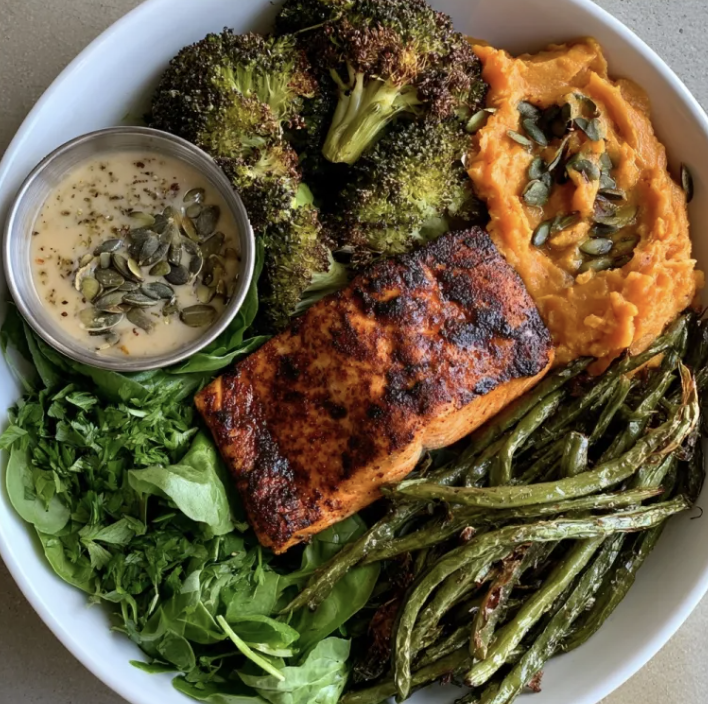 Southern Omega Bowl with Southern Blackened Salmon, Sweet Potato Mash, Broccoli, Green Beans, Spinach, Parsley, Pumpkin Seeds, Charred Lemon & Caper Dijon Sauce