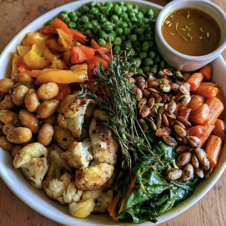 Fall Fiber Bowl with Butter Bean Stew, Steamed Green Peas, Cauliflower, Bell Peppers, Carrots, Swiss Chard, Pumpkin Seeds, Thyme, Smoky Porcini, Rosemary & Carrot Broth