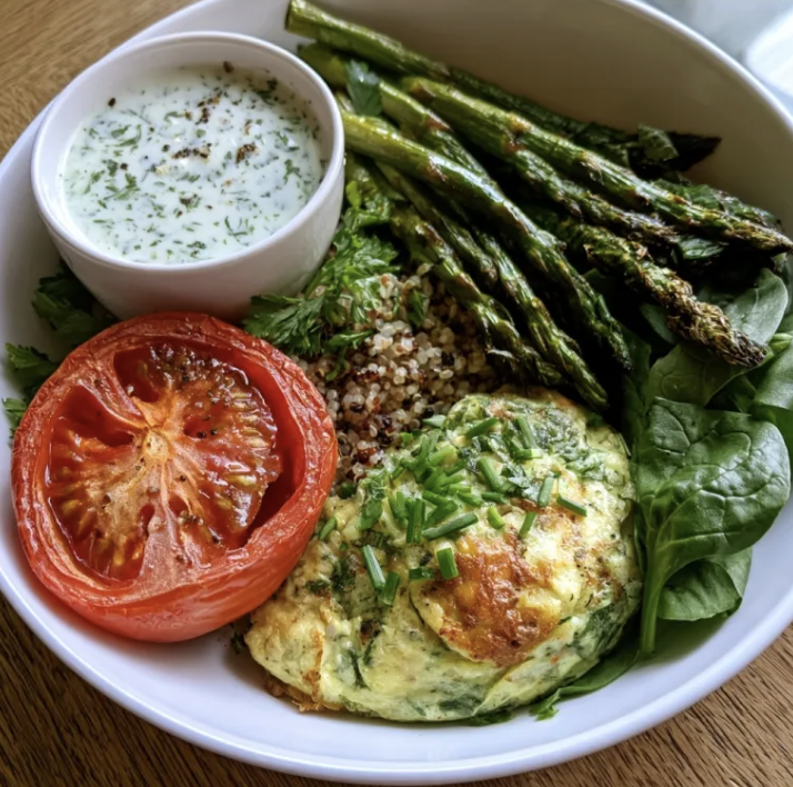 Garden Breakfast Bowl with Leek Tomato Frittata, Quinoa, Roasted Tomatoes, Roasted Asparagus, Fresh Spinach, Chives, Parsley, Creamy Basil & Parmesan Yogurt Sauce