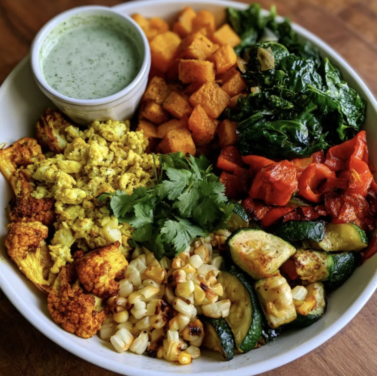 Turmeric Sunrise Bowl with Egg Bhurji, Butternut Squash, Turmeric Cauliflower, Kale, Zucchini, Red Peppers, Corn, Cilantro, Creamy Cilantro Lime Dressing