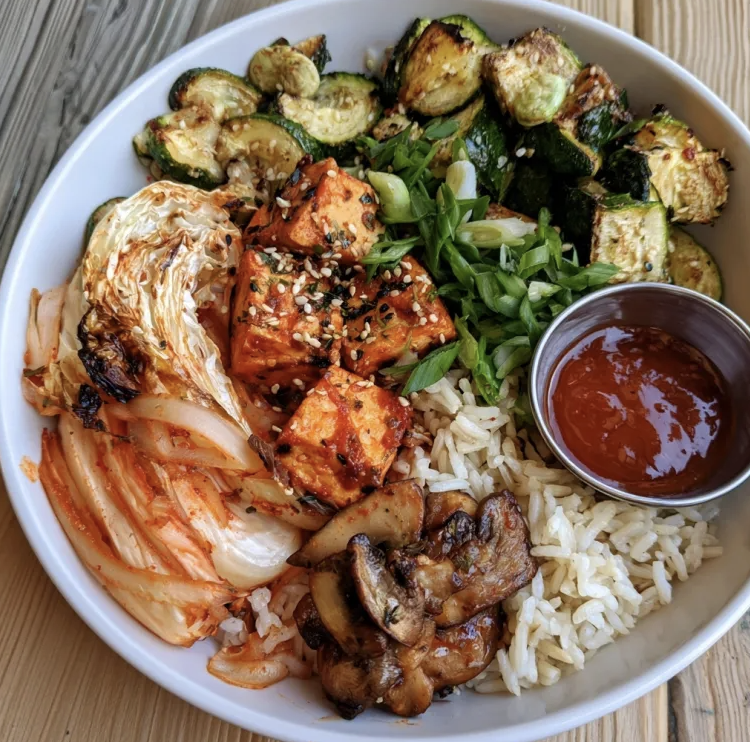 Probiotic Kimchi Bowl with Kimchi Tofu, Basmati Rice, Napa Cabbage, Zucchini, Pickled Daikon Noodles, Button Mushroom, Scallion, Korean BBQ Sauce