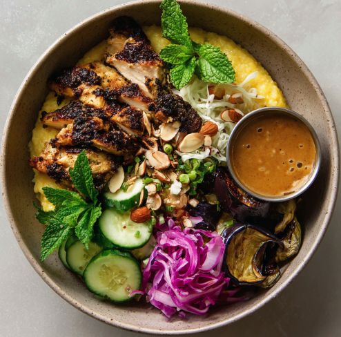 For Pros: Immune Strength Bowl with Za'atar Chicken, Polenta, Roasted Eggplant, Shredded Cabbage, Cucumber, Pickled Red Onion, Fresh Mint, Toasted Almonds, and a Date-Ginger Spice Sauce