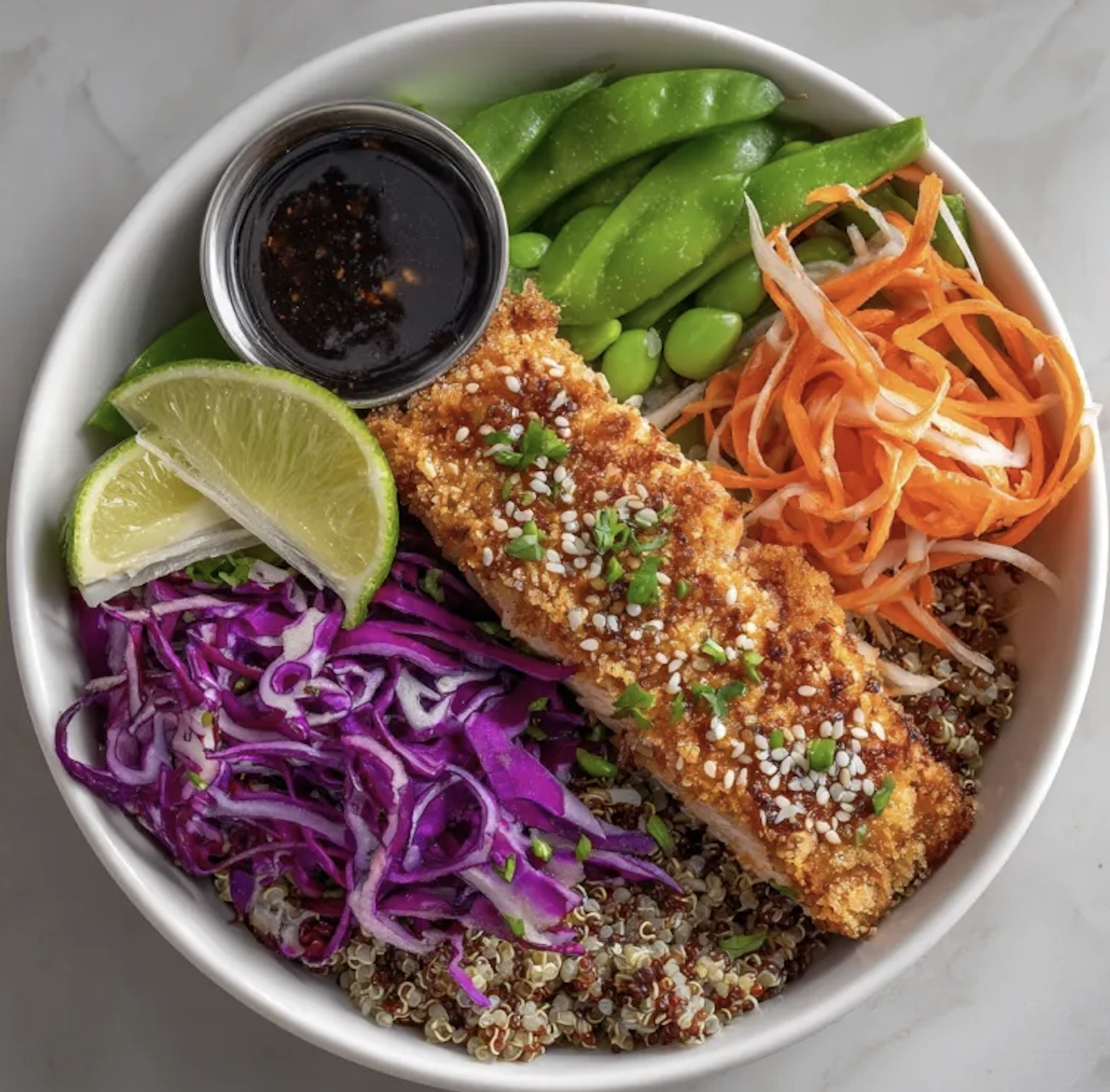 Sesame Omega Bowl with Sesame Crusted Salmon, Quinoa, Red Cabbage, Shredded Carrot and Burdock Slaw, Snap Peas, Sesame Seeds, Lime, Sesame Ginger Dressing