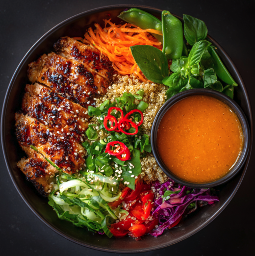 For Orca: Nuoc Cham Gazpacho Bowl with Lemongrass Grilled Chicken, Quinoa, Green Cabbage, Snap Peas, Carrot, Eggplant, a Nuoc Cham–Tomato Gazpacho, Pickled Red Chili, Thai Basil, and Sesame Seeds