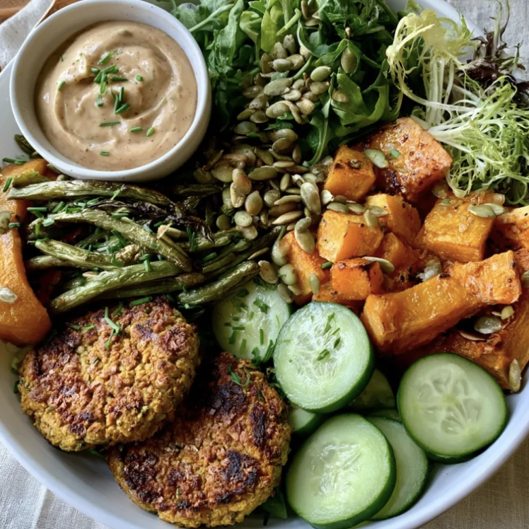 Fall Harvest Bowl with Harvest Chickpea Veggie Patties, Butternut Squash, Green Beans, Cucumbers, Arugula, Frisée, Chives, Pumpkin Seeds, Charred Apple Tahini