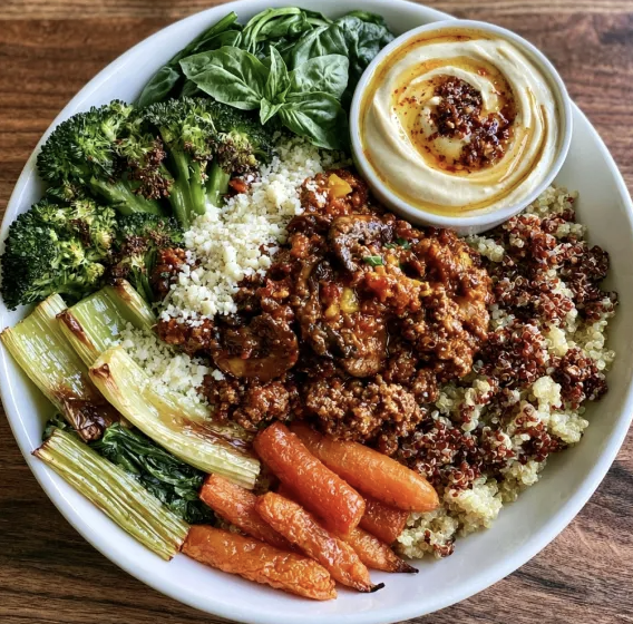 Umami Fiber Bowl with Wild Mushroom Bolognese, Quinoa, Broccoli, Celery, Carrots, Spinach, Basil, Parmesan, Roasted Garlic Cashew Crema