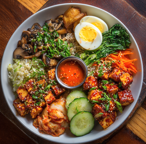 For Pros: Korean Fire Bowl with Gochujang Tofu, Brown Rice, Mushrooms, Kimchi Cucumbers, Shredded Carrots, Bok Choy, Sesame Seeds, Scallions, Egg, Sesame Scallion Dressing
