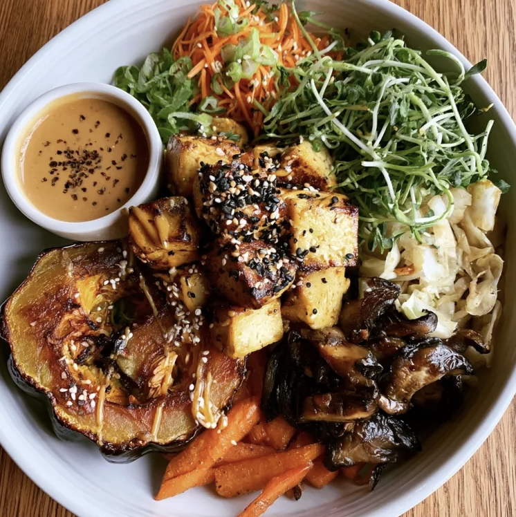 For Pros: Satay Glow Bowl with Peanut Tofu, Roasted Acorn Squash, Sautéed Mushrooms, Carrots, Napa Cabbage, Pea Shoots, Scallions, Sesame Seeds, Peanut Sauce