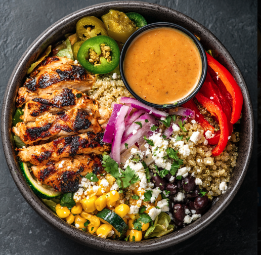 For Orca: Mexican Fajita Bowl with Grilled Chicken, Quinoa, Black Beans, Roasted Bell Peppers, Corn, Zucchini, Cabbage, Red Onions, Chipotle Yogurt Sauce, Pickled Jalapeños, Cotija, Cilantro